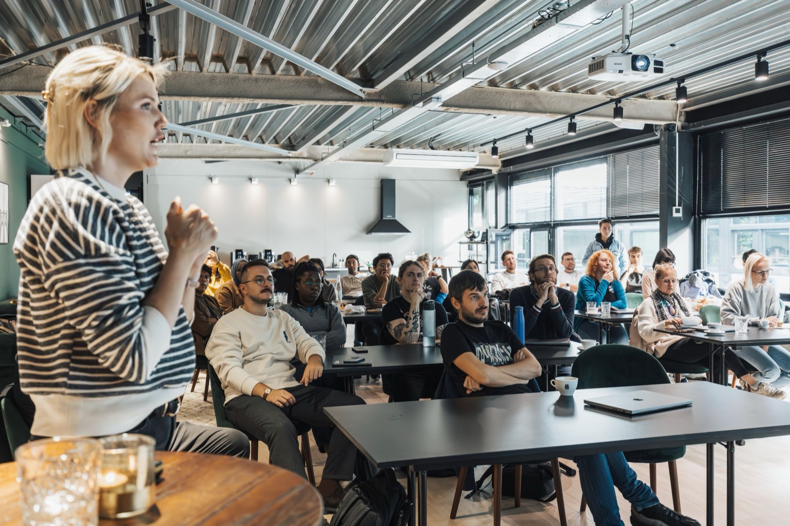 A workshop in an office, the room seated and listening.